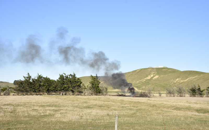 Outdoor controlled rural burnoff in field. 
